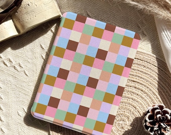 May include: A rectangular case with a colorful checkered pattern in shades of brown, pink, blue, green, and cream. The case is placed on a textured surface, with the Glow Dwell Designs logo visible.