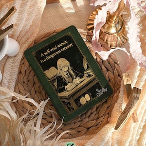 May include: A green phone case featuring an illustration of a woman reading at a desk, with the text "A well-read woman is a dangerous creature." The case is personalized with the name "Sophia" and font #1.