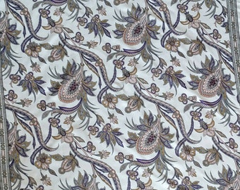 May include: Square scarf with a cream background and a repeating paisley pattern in shades of purple, brown, and green. The scarf has a decorative border with a repeating design.