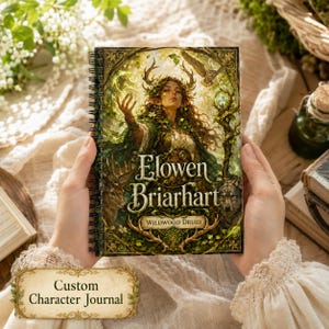 May include: A spiral-bound journal featuring a fantasy illustration of a druid with antlers, surrounded by forest elements including an owl, a deer, and a wolf. The cover displays the text Elowen Briarhart and Wildwood Druid in gold lettering.
