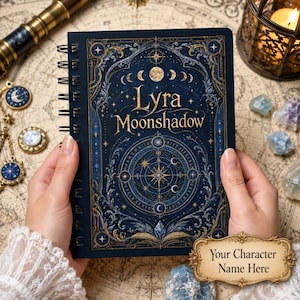 May include: A dark blue spiral-bound notebook featuring gold celestial illustrations, moon phases, and the text Lyra Moonshadow. The cover displays an intricate compass design with stars and filigree, accompanied by a gold plaque with the text Your Character Name Here.