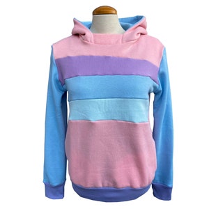 May include: A pastel blue, pink, and purple striped hoodie with a hood.