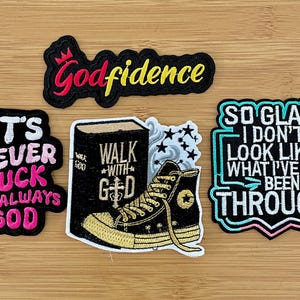 May include: A collection of embroidered patches with inspirational quotes. The patches feature phrases like "Godfidence," "It's Never Luck, It's Always God," and "So Glad I Don't Look Like What I've Been Through." One patch depicts a sneaker and a book.