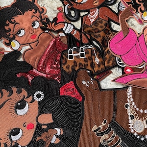 May include: Embroidered patches featuring cartoon women with dark skin tones. The patches showcase various outfits, including a red sequined dress, a leopard print dress, and a pink jacket. Accessories include jewelry, handbags, and roses. The patches are detailed with black outlines.