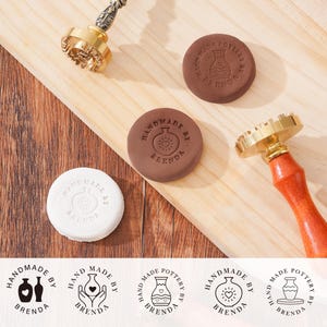 May include: A collection of pottery stamps and clay impressions. The stamps have brass heads and wooden handles. The clay impressions are brown and white, each with the text "HANDMADE POTTERY BY BRENDA" and a vase design.