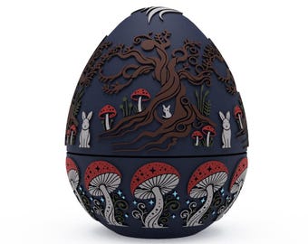 May include: A blue egg-shaped ceramic ornament with a detailed design of a tree, mushrooms, and rabbits. The bottom half of the egg features a repeating pattern of mushrooms and stars.