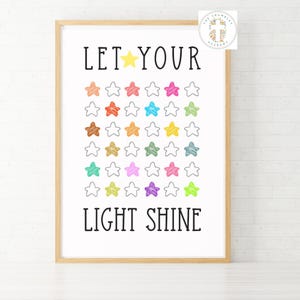 May include: A white poster with a wooden frame, featuring the text "LET YOUR LIGHT SHINE" in black. The poster is decorated with a grid of colorful stars.