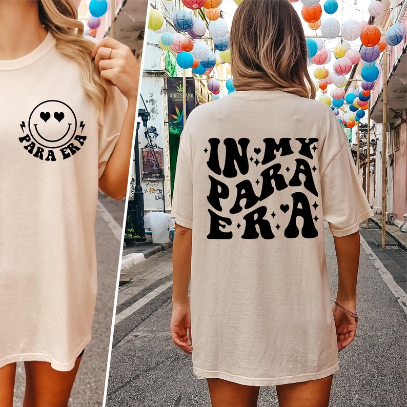 May include: A beige t-shirt with a black smiley face with hearts for eyes and the text "Para Era" on the front. The back of the shirt has the text "In My Para Era" in a retro font.