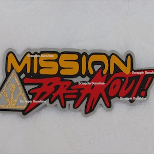 May include: A silver, red, and yellow sticker with the text "Mission Breakout!" and a gold triangle with a stylized figure inside. The text "Scrapin Sunshine" appears four times on the sticker.