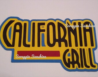 May include: A yellow and blue die-cut sign with the text "CALIFORNIA GRILL" in black lettering. The text "Scrapppin Sunshine" is written in white lettering on a red stripe below the main text.