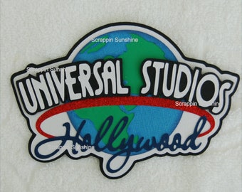 May include: A black and white Universal Studios Hollywood logo with a red and glitter ring around a blue and green globe. The text "Scrappin Sunshine" appears at the top of the logo.