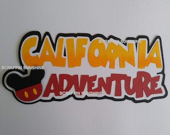 May include: A red and yellow paper craft with the text "California Adventure" and a black Mickey Mouse head with red ears and yellow circles for eyes.