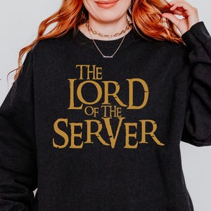 May include: Black sweatshirt with gold text that reads "The Lord of the Server".