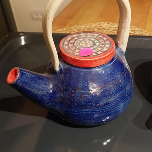 Title: Handcrafted Ceramic Teapot with Artistic Design
