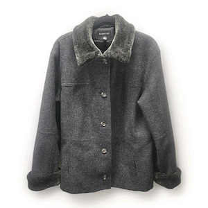 May include: A charcoal gray jacket with a faux fur collar and cuffs. The jacket has a button-up front and a tailored fit. The brand name "Signature" is visible on the collar. The jacket is hanging on a black hanger against a white background.