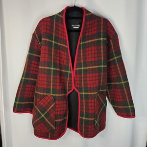 May include: A vintage plaid jacket in red, gray, and yellow, with a red trim. The jacket has two front pockets and a collarless design. The label reads "french vanilla".