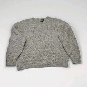 May include: A grey Lands' End sweater with a V-neck collar. The sweater has long sleeves and a speckled knit pattern. The Lands' End label is visible at the back of the neck. The sweater is made of a soft, comfortable material.