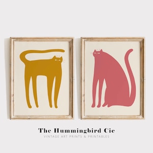 Puede incluir: Dos ilustraciones minimalistas de gatos en marcos. El gato de la izquierda es amarillo y el gato de la derecha es rosa.