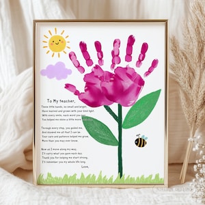 May include: A framed print with a handprint flower design. The flower is a pink handprint, with a green stem and leaves. A yellow sun, purple cloud, and a bee are also included. The text reads "To My teacher, Love."