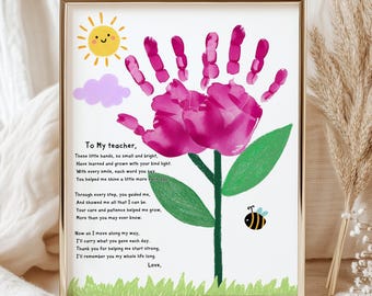 May include: A framed print featuring a handprint flower design. The flower is made from a pink handprint, with a green stem and leaves. A yellow sun, purple cloud, and a bee are also included. The text reads "To My teacher, Love."