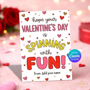 May include: A Valentine's Day card with the message "hope your VALENTINE'S DAY is SPINNING with FUN!" in pink, yellow, and red. The card is decorated with hearts and dots. The bottom of the card says "from: Add your name".