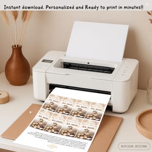 May include: A white printer producing sheets of "Thank You" tags featuring a teddy bear design. The text "Instant download. Personalized and Ready to print in minutes!!" is at the top. The brand name "NIRISUN DESIGNS" is at the bottom.