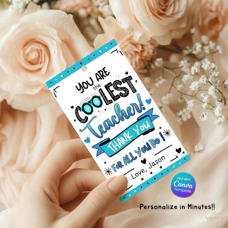 May include: A white gift tag with a blue border and the text "YOU ARE the COOLEST Teacher! THANK YOU FOR ALL YOU DO!" in a handwritten style. The tag includes the text "Love, Jason" and is decorated with hearts and stars.
