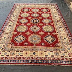 Handmade Afghan Kazak Wool Rug: 6x9 Red Geometric Boho Rug