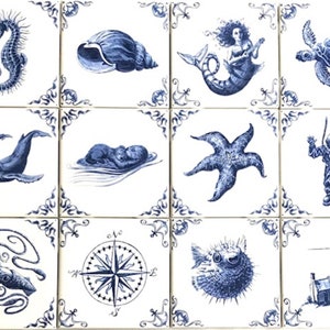 May include: A set of twelve square ceramic tiles with blue and white illustrations of marine life and nautical elements. Designs include a seahorse, seashell, mermaid, sea turtle, whale, starfish, diver, octopus, compass, pufferfish, and lighthouse.