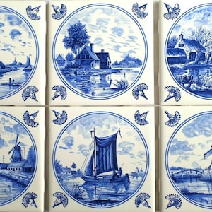 May include: Six square ceramic tiles with blue and white landscape paintings. Each tile features a different scene, including windmills, boats, and houses, all framed by a circular border with decorative elements. The tiles are arranged in a two-by-three grid.