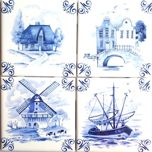 May include: Four square ceramic tiles with blue and white illustrations. Each tile depicts a different scene: a house, a building with a bridge, a windmill, and a sailboat. Decorative blue swirls are in each corner.