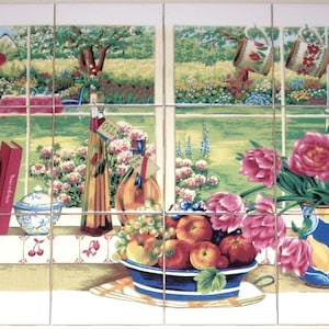 May include: A decorative tile set featuring a kitchen scene. The image depicts a window overlooking a garden, with a bowl of fruit, flowers, and bottles of oil. Books and a decorative jar are also visible. The color palette includes greens, blues, and reds.