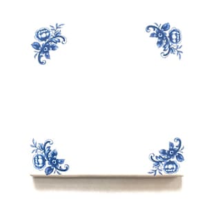 May include: White background with four blue floral corner designs. Each corner features a cluster of blue flowers and leaves. A light beige shelf is at the bottom, with the floral designs above it.