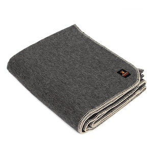 May include: A gray wool blanket with a white stitched border. The blanket is folded in half and has a small label with the word "Alpaca" on it.