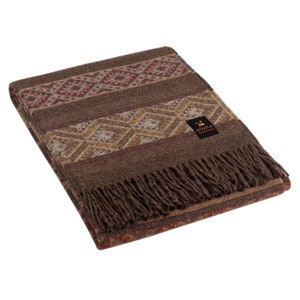 May include: A brown alpaca throw blanket with a geometric pattern in shades of brown, beige, and red. The blanket has a fringe border and a small label that reads "Alpaca Warehouse".