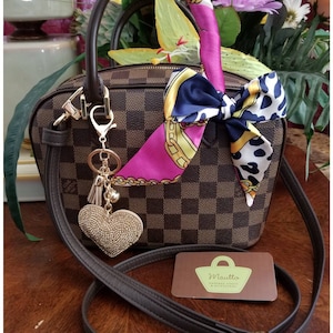 Photo from a customer showing their DE strap attached to their LV handbag.