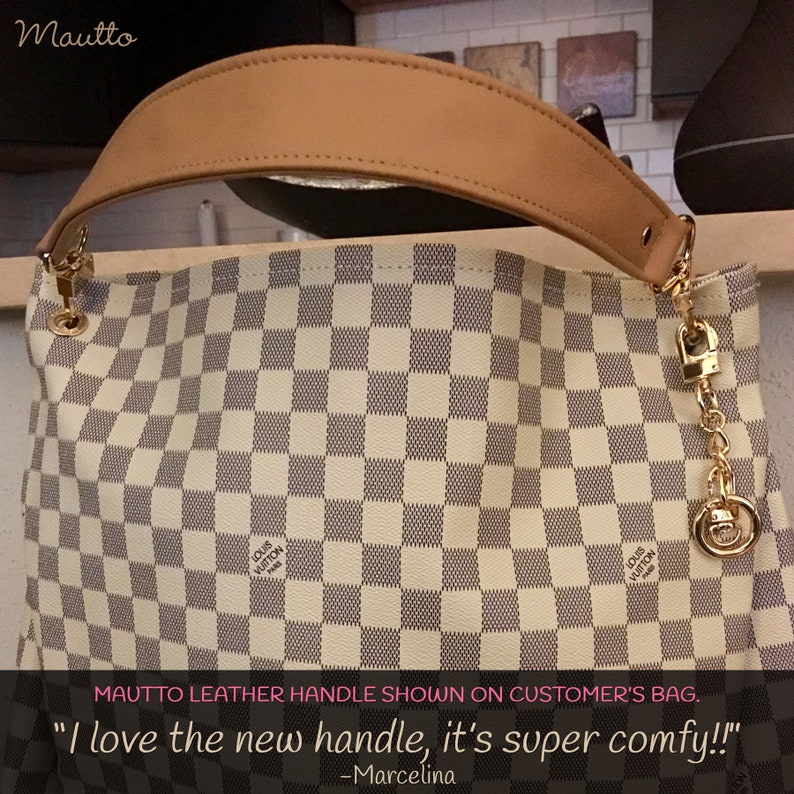 Short shoulder tan leather strap shown on a customer's bag.