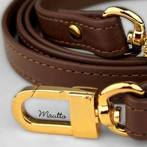 Zoom view of dark brown leather purse strap.