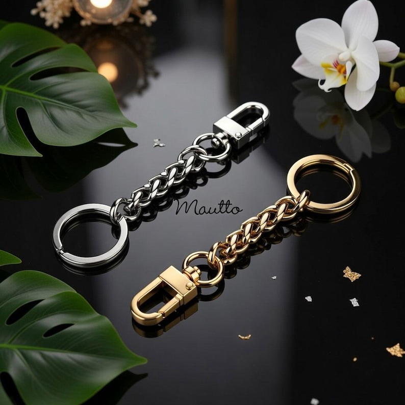 Purse accessory to keep keys safely tethered to your handbag. Gold and silver metal finishes available.