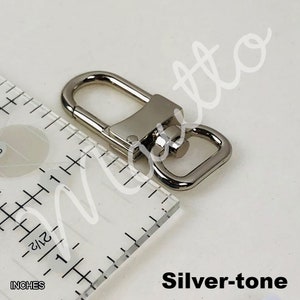 Silver-tone swiveling clip in U-shape design.