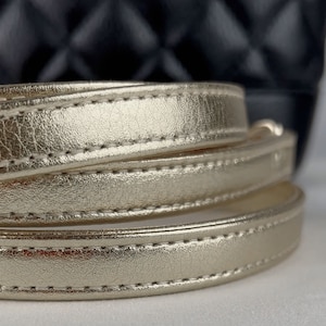 Close-up view of Light Gold / Champagne metallic leather strap.