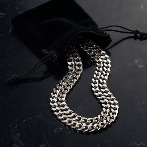 Polished silver fancy link chain strap for bags, purses, clutches, night out bags, handbags, cell phone cases, necklaces and more. Shown on display with a black storage pouch / dust bag.