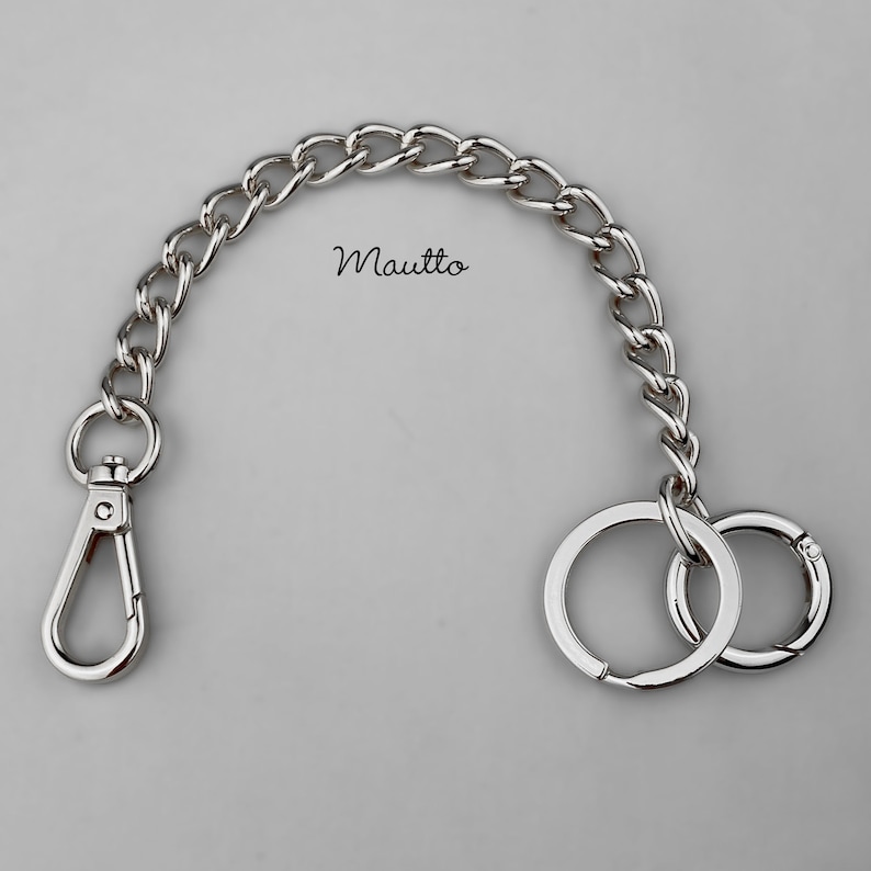 Luxury chain key fob tether and handbag accessory. Attachable clip and keyring / o-ring accessory, to secure your keys to your bag or clothing. Jewelry quality metal chain. Made by hand in the USA. Silver-tone finish shown.