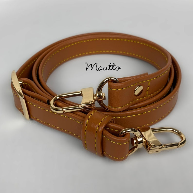 Dark Tan leather strap with accent yellow/gold stitching. Adjustable configuration for shoulder to cross body lengths.