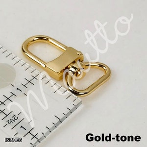 Gold-tone swiveling clip in U-shape design.