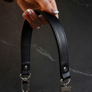 Tapered width short shoulder or crook of arm strap. Choice of genuine leather and clip/hook style. Shown with silver hardware.