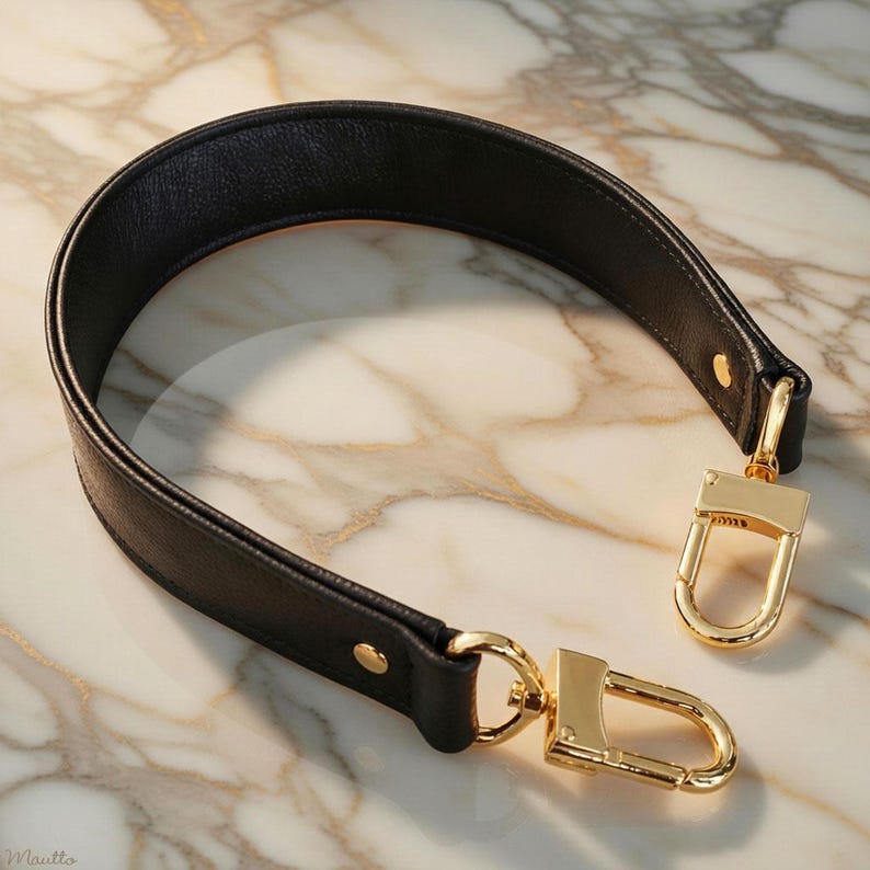 Tapered width short shoulder or crook of arm strap. Choice of genuine leather and clip/hook style. Shown in Black leather.