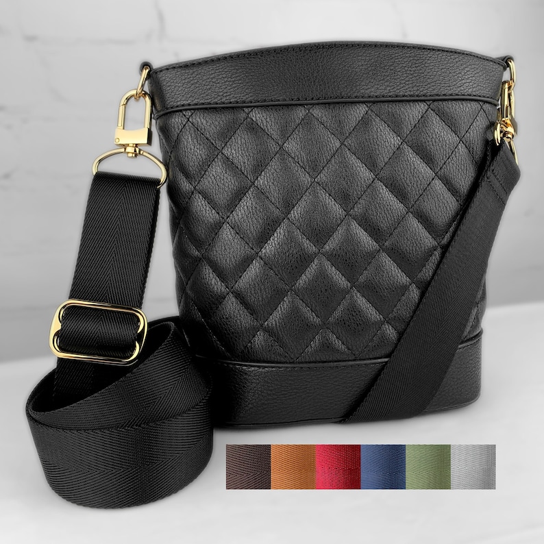 Photo of woven webbing purse strap, guitar-style strap on a black handbag.