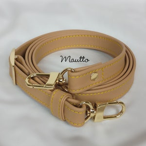 Light Tan leather strap with accent yellow/gold stitching. Adjustable configuration for shoulder to cross body lengths.
