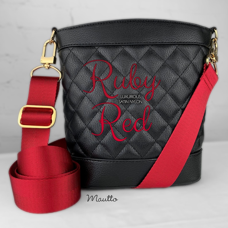 Photo of red woven purse strap on purse. Adjustable shoulder to cross body length.